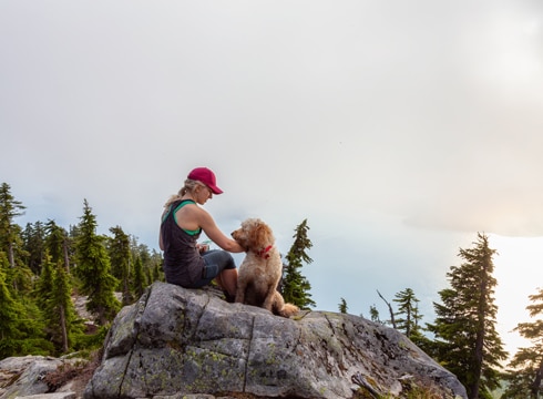 Woman on mountain with dog in Mission