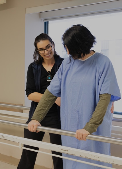 A Fraser Health physiotherapist doing mobility exercises with a patient.